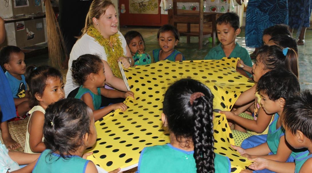 A Projects Abroad volunteer teaches at a local school during her cultural immersion in Samoa. A volunteer in a village in Samoa teaches a class at a local school.